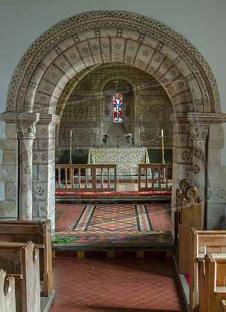 Norman choir arch, with Victorian decoration: St George, Hampnett