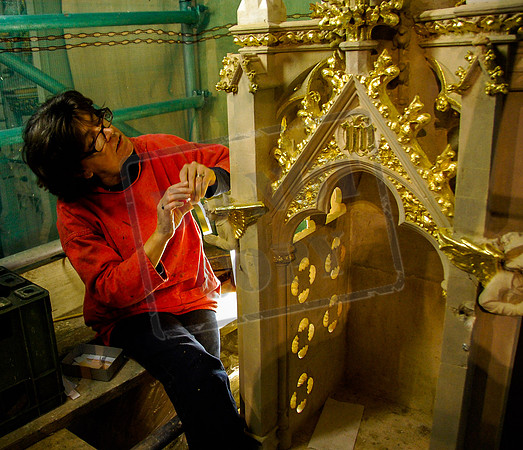 Teresa Llewellyn at work with gold leaf in St Gregory's, Cheltenham